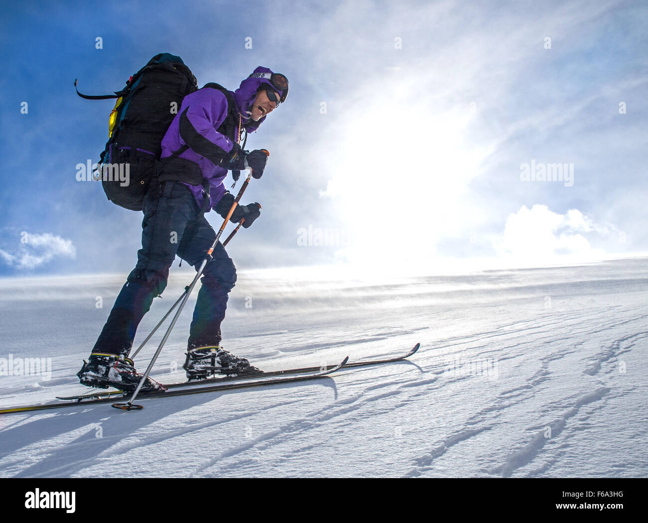 A ski tourer struggles into the wind on a Norwegian mountain Stock Photo