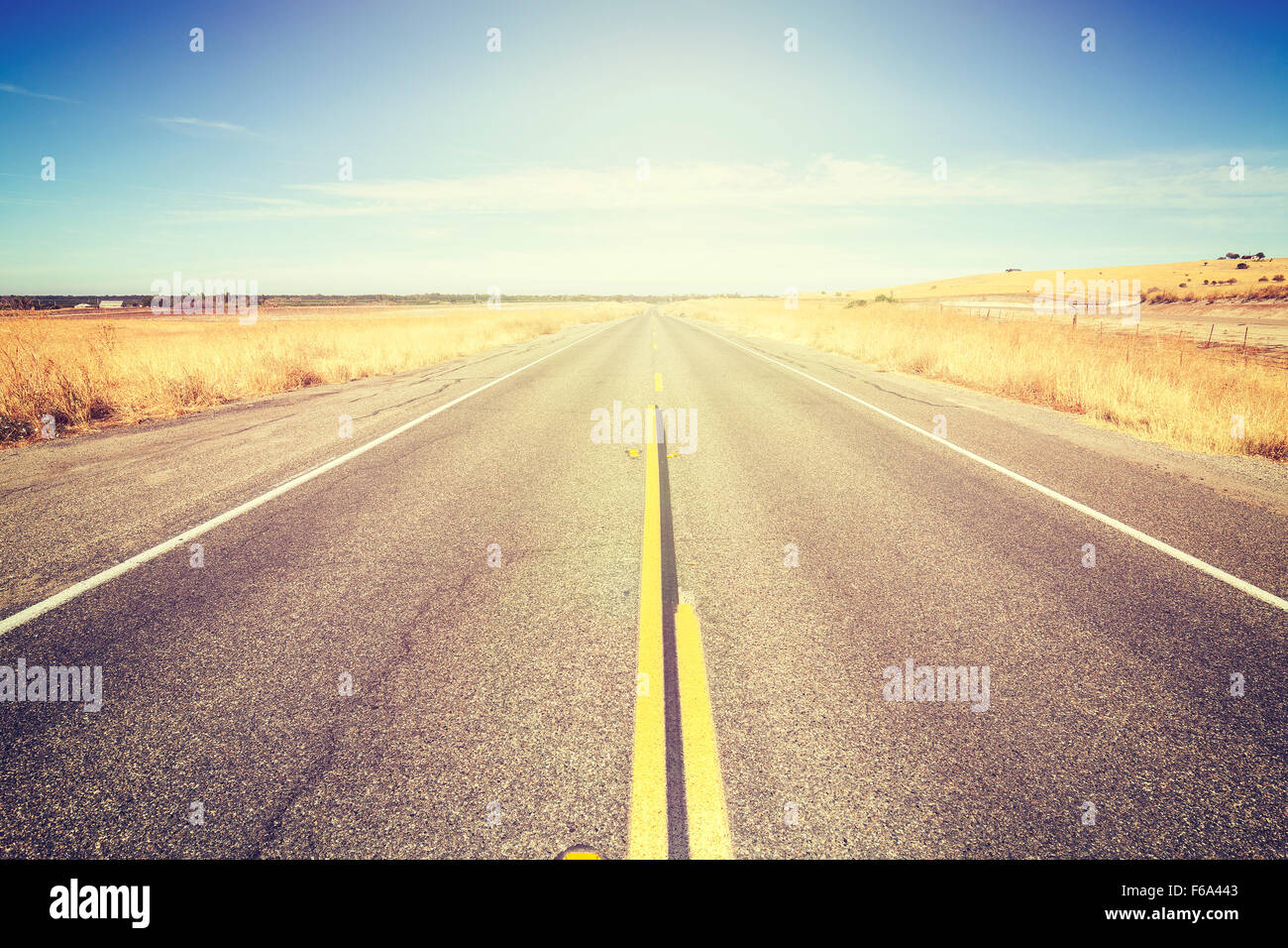 Vintage toned endless country road, travel concept picture. Stock Photo