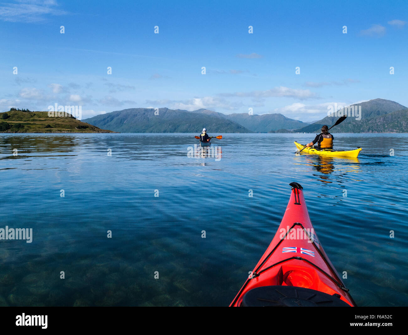 Group of retired people sea kayaking around Shuna Island on Loch Linnhe, West Scotland Stock Photo