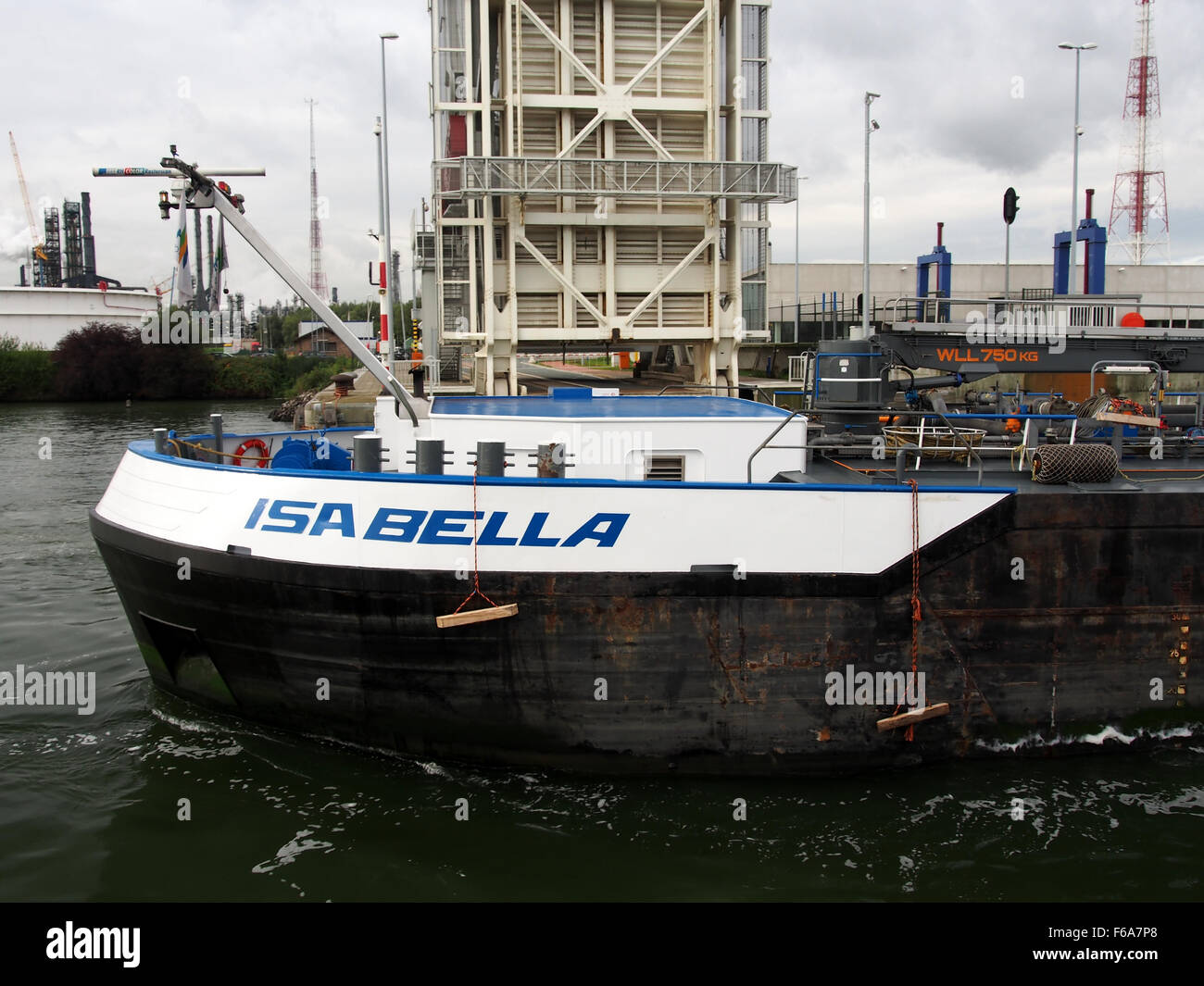 The Isabella is a container ship with ENI 02330132, photographed in the Port of Antwerp in 2008. The ship is a key part of global logistics, transporting general goods and cargo including containers, gas, coal, and grain. The image highlights the significance of container shipping and the logistics infrastructure. Stock Photo