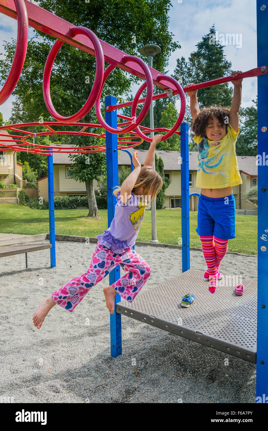 Young children on playground bars. Stock Photo