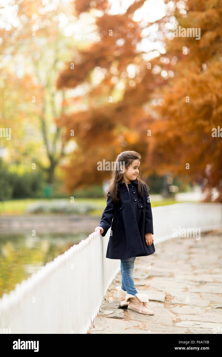 Little girl in the autumn park Stock Photo - Alamy