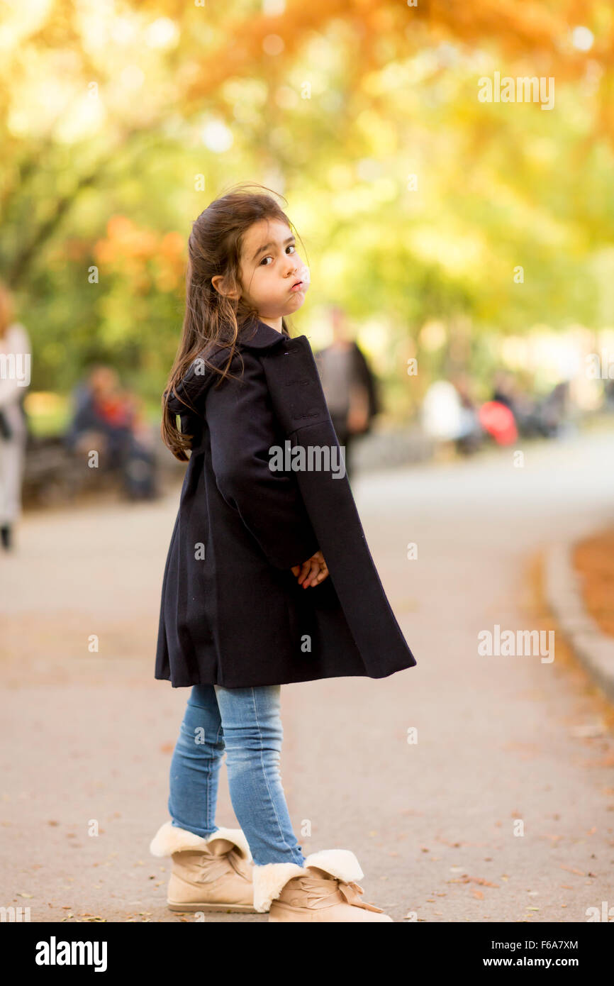 Little girl in the autumn park Stock Photo - Alamy