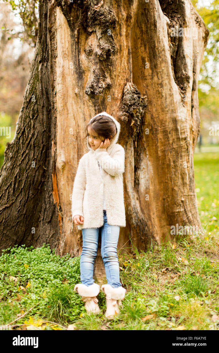Little girl in the autumn park Stock Photo - Alamy