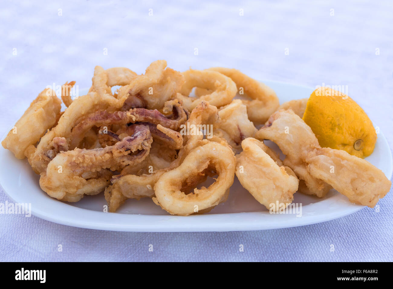 Fried Calamari and lemon Stock Photo