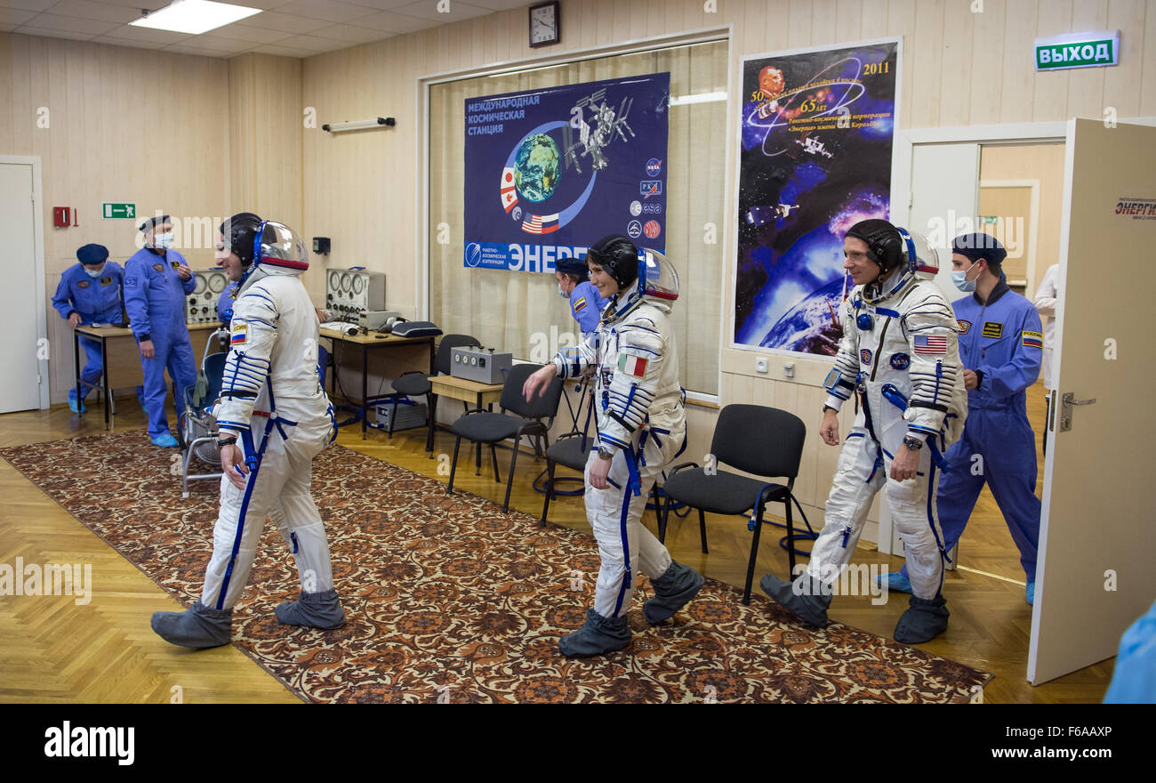Expedition 42 crew members, Soyuz Commander Anton Shkaplerov of the Russian Federal Space Agency (Roscosmos), left, Flight Engineer Samantha Cristoforetti of the European Space Agency (ESA), center, and Flight Engineer Terry Virts of NASA, right, prepare for pressure checks of their Sokol suits in Building 254 following their suit up for launch, Sunday, Nov. 23, 2014, at the Baikonur Cosmodrome in Kazakhstan. Launch of the Soyuz rocket is scheduled for the early hours of Nov. 24 and will carry Virts, Shkaplerov, and Cristoforetti into orbit to begin their five and a half month mission on the I Stock Photo