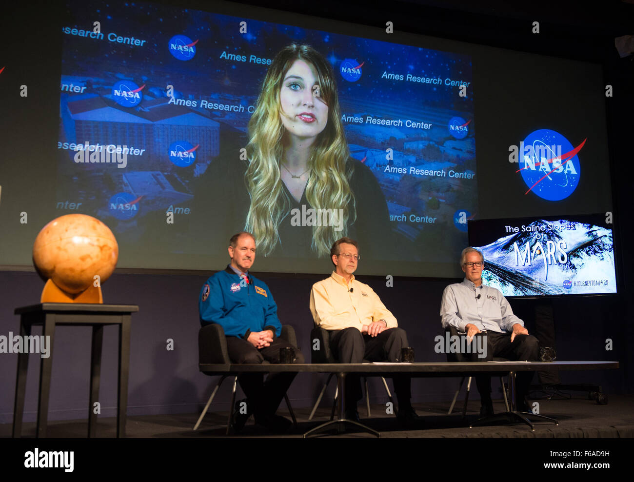 Panelists, from left to right, John Grunsfeld, associate administrator, science mission, NASA; Jim Green, director of planetary science, NASA; and Michael Meyer, lead scientist, Mars Exploration Program, NASA, listen to a presentation via phone by Mary Beth Wilhelm of NASA’s Ames Research Center at a news briefing announcing the presence of water on Mars on Monday, September 28, 2015 at NASA Headquarters in Washington, DC. The findings are being presented this week at the European Planetary Science Congress in France and are detailed in a research paper titled, "Spectral Evidence for Hydrated Stock Photo