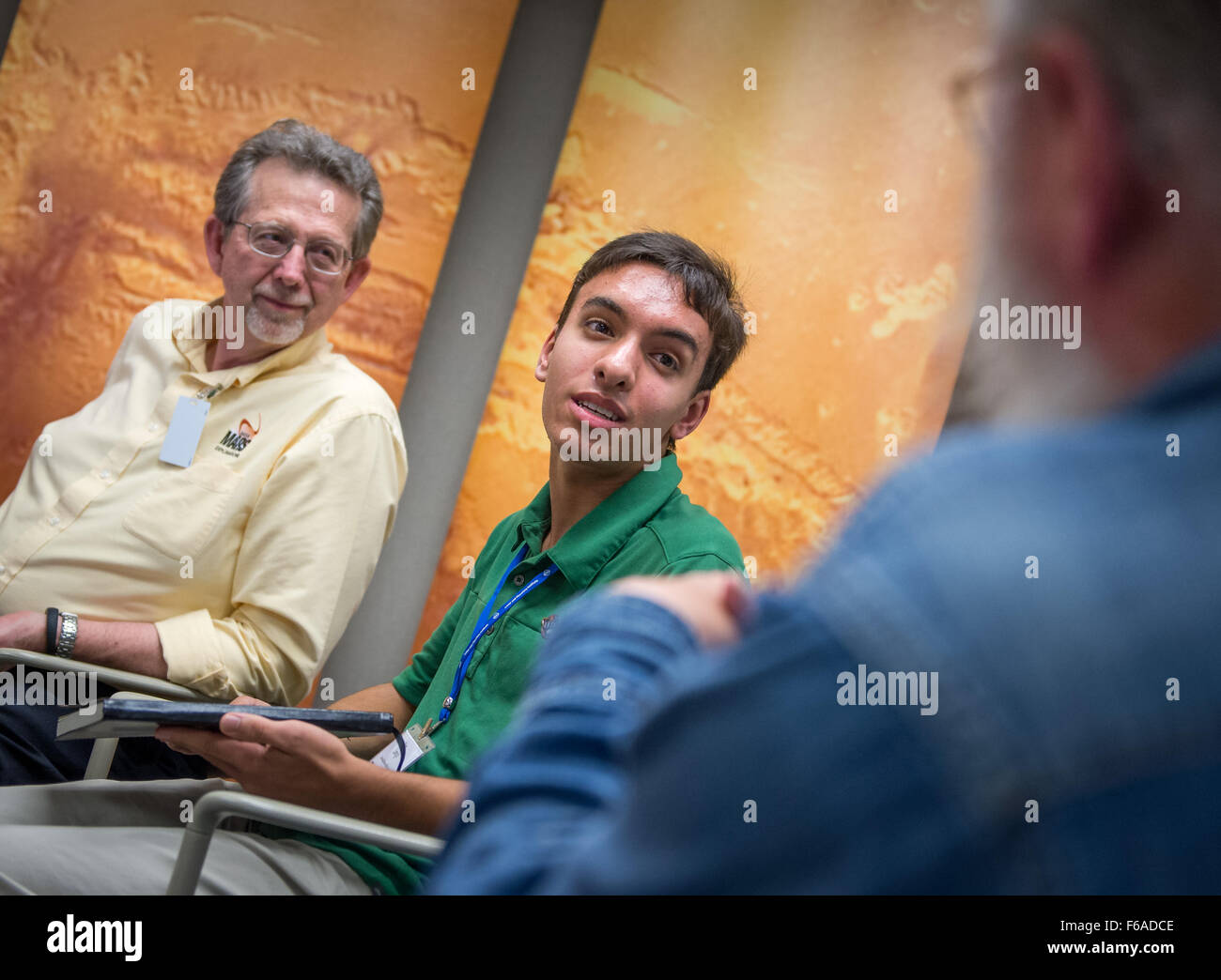 Alex Longo, a 15-year old student from Cardinal Gibbons High School, answers reporter's questions as Jim Green, director of the Planetary Science Division at NASA Headquarters looks on following the First Landing Site/Exploration Zone Workshop for Human Missions to the Surface of Mars held at the Lunar and Planetary Institute, Friday, Oct. 30, 2015, in Houston, Texas. The agency is hosting the workshop to collect proposals for locations on Mars that would be of high scientific research value while also providing natural resources to enable human explorers to land, live and work safely on the R Stock Photo