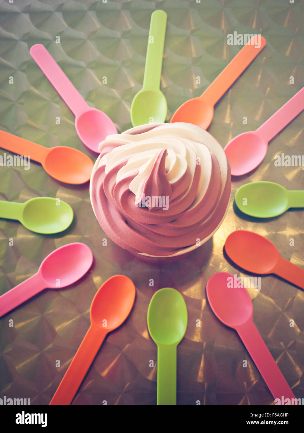 Spoons and cup with frozen soft serve yogurt Stock Photo Alamy