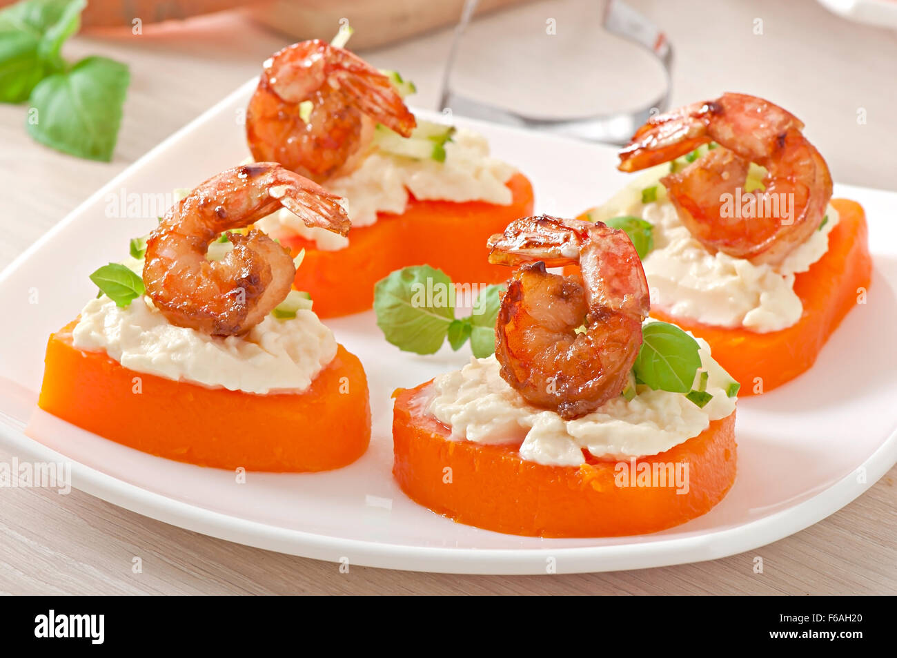 Appetizer of shrimp and cream cheese on pumpkin hearts Stock Photo Alamy
