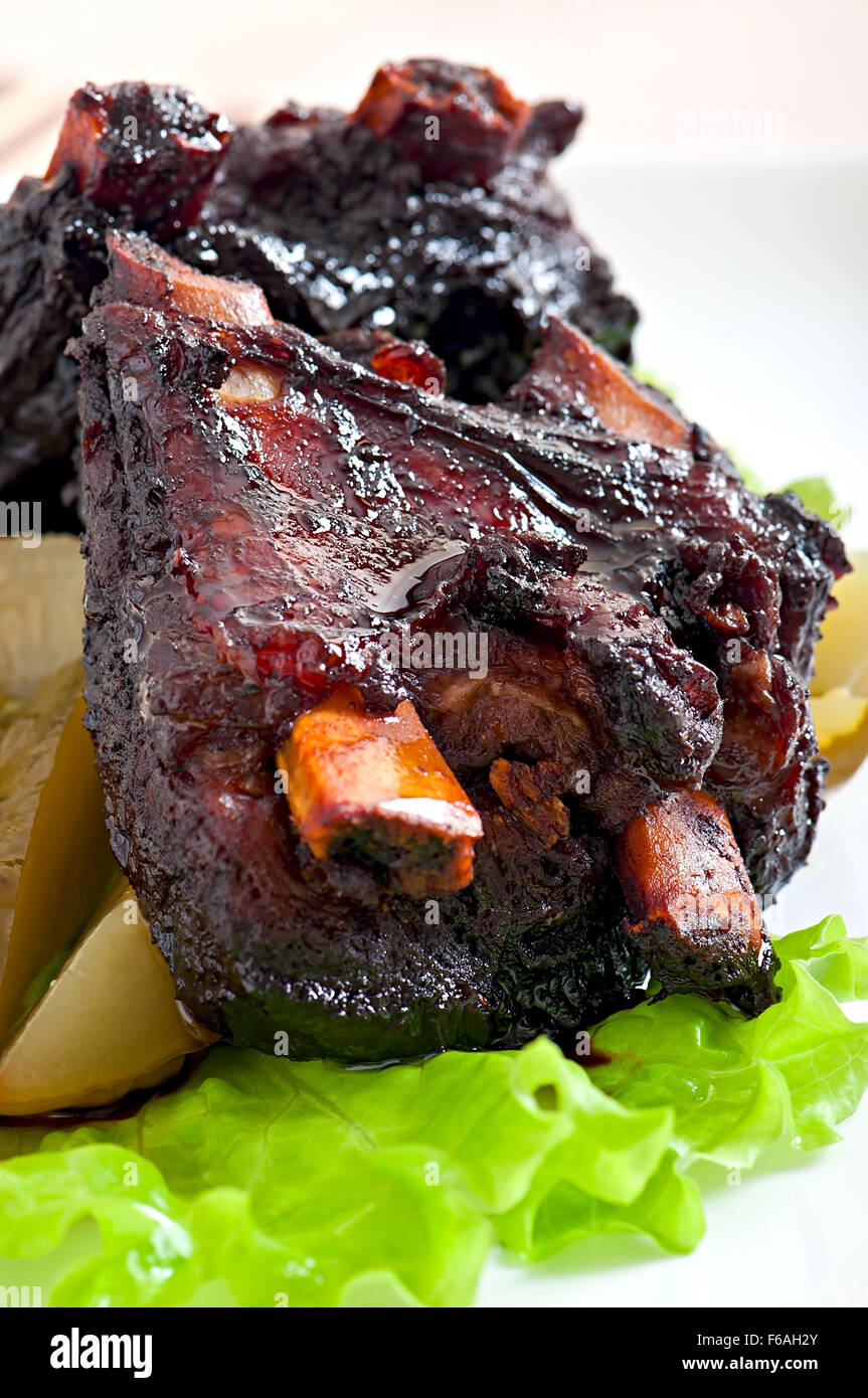 Baked beef ribs in honey soy marinade with pickled vegetables Stock Photo
