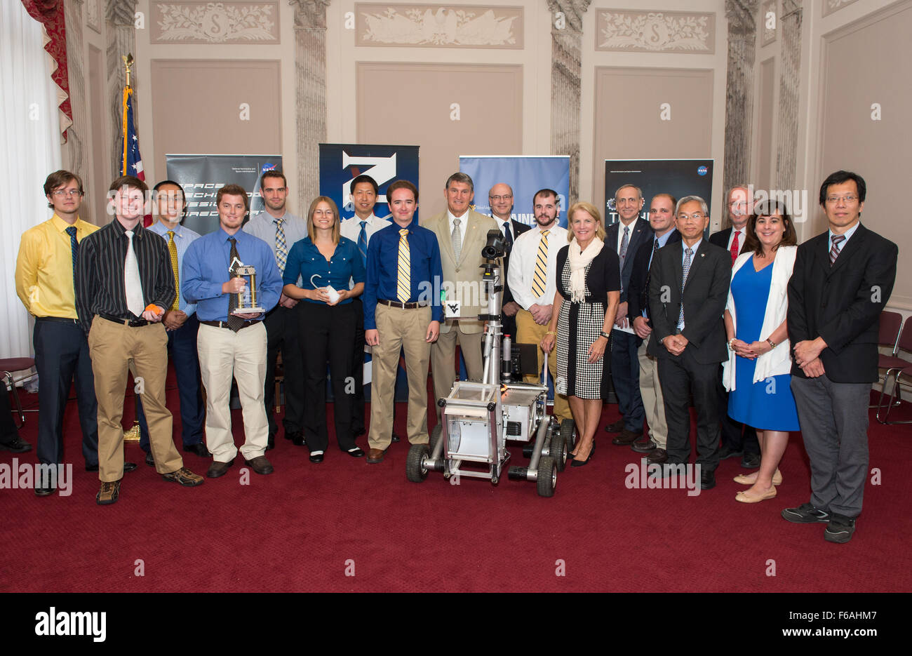 The winners of the 2015 Sample Return Robot Challenge, the Mountaineers Team, pose for a photo with Senator Joe Manchin (D-W.Va); Senator Shelley Moore Capito (R-W.Va); Steve Jurczyk, associate administrator, Space Technology, NASA;  Dr. David A. Wyrick, associate dean of West Virginia University's Statler College of Engineering and Mineral Resources; Dr. Yu Gu, Assistant Professor, West Virginia University; and other NASA and West Virginia University staff before providing a demonstration of their robot on Monday, Sept. 21, 2015 at the Russell Senate Office Building in Washington, DC. The Mou Stock Photo