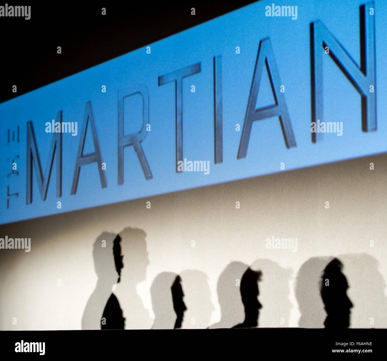 The silhouettes of Moderator Angela Watercutter of WIRED magazine, left, NASA Astronaut Drew Feustel, Actor Matt Damon, and Director Ridley Scott are seen as they participate in a question and answer session about NASA’s journey to Mars and the film ”The Martian,'  Tuesday, Aug. 18, 2015, at the United Artist Theater in La Cañada Flintridge, California. NASA scientists and engineers served as technical consultants on the film. The movie portrays a realistic view of the climate and topography of Mars, based on NASA data, and some of the challenges NASA faces as we prepare for human exploration  Stock Photo