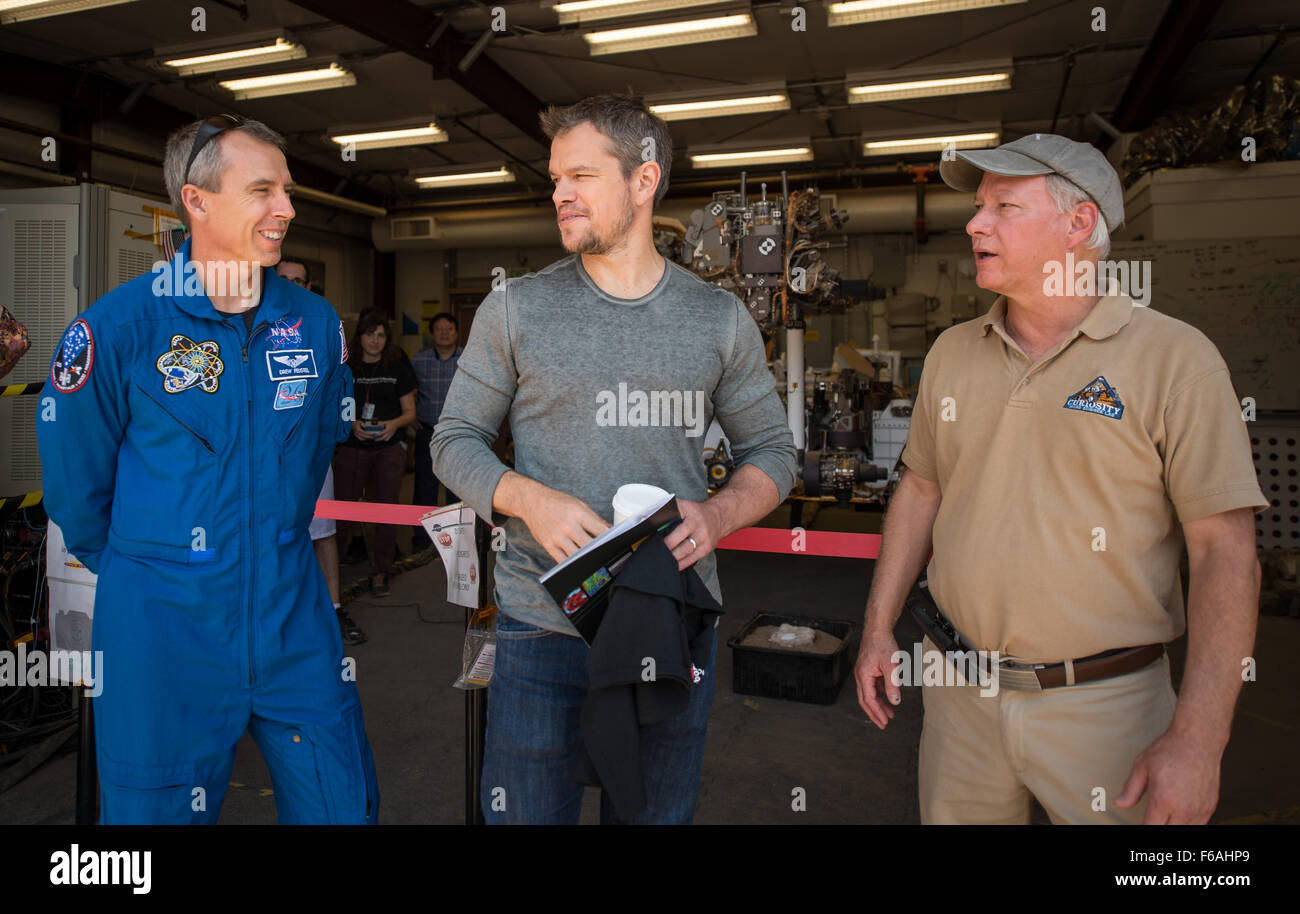 NASA Astronaut Drew Feustel, left, Actor Matt Damon, who stars as NASA Astronaut Mark Watney in the film “The Martian,” and Mars Science Lab Project Manager Jim Erickson, talk at the Jet Propulsion Laboratory (JPL) Mars Yard, Tuesday, Aug. 18, 2015, at JPL in Pasadena, California. While at JPL Damon meet with NASA scientists and engineers who served as technical consultants on the film. The movie portrays a realistic view of the climate and topography of Mars, based on NASA data, and some of the challenges NASA faces as we prepare for human exploration of the Red Planet in the 2030s. Photo Cre Stock Photo