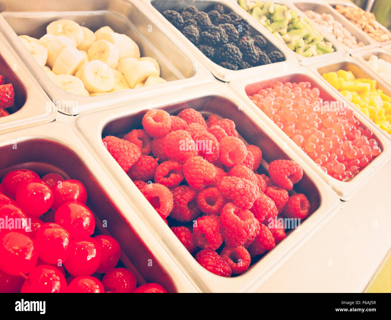 Frozen yogurt toppings bar. Yogurt toppings ranging from fresh fruits