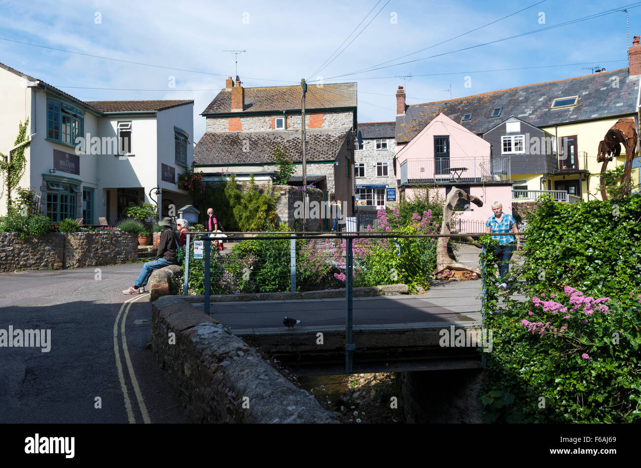 Shops and restaurants surrounding the town mill and river in Lyme Regis, Dorset, England, UK Stock Photo
