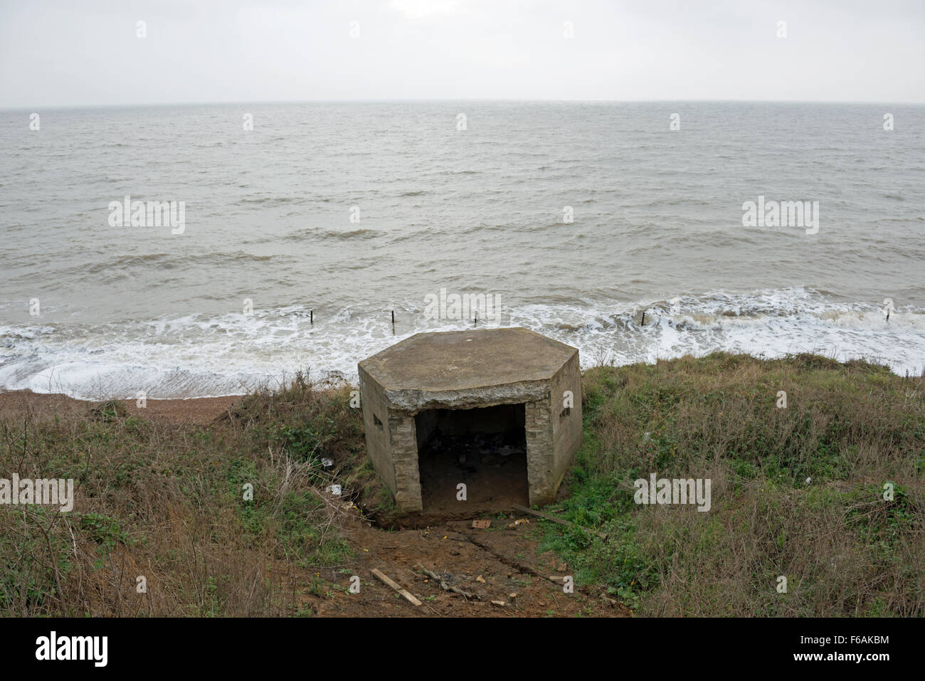 WW2 pillbox which has fallen from the top of the cliff due to coastal erosion Bawdsey Suffolk UK Stock Photo