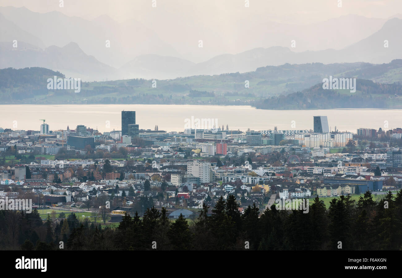 The Swiss city of Zug and Baar with Lake Zug and Swiss mountains in the background. Stock Photo