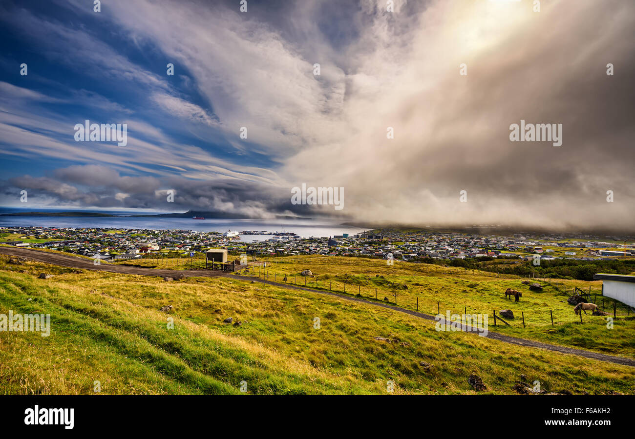 Dramatic change of weather over Torshavn, the capital and largest city of the Faroe Islands, Denmark. Hdr processed. Stock Photo