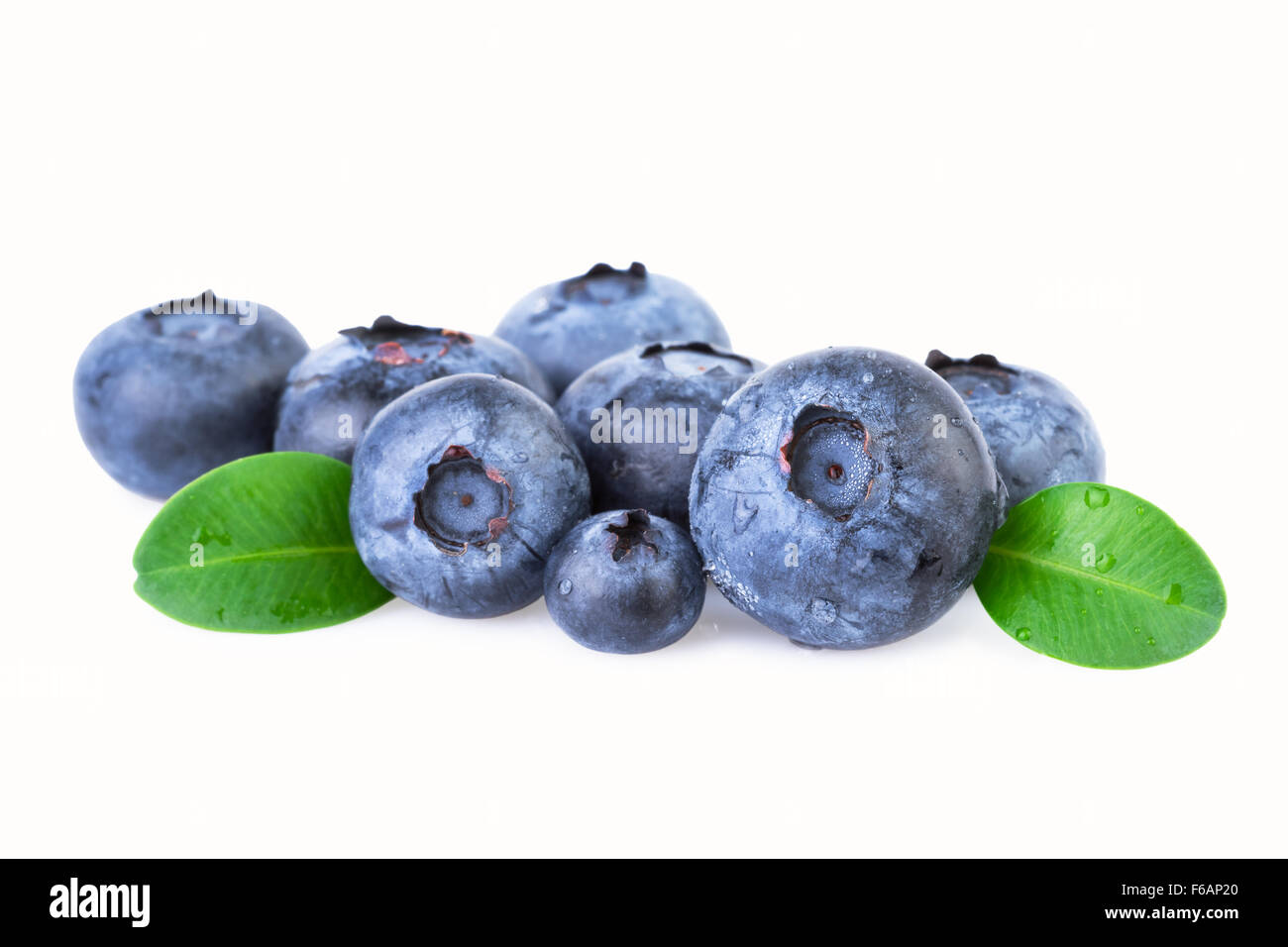 Blueberries with green leafs isolated on white Stock Photo