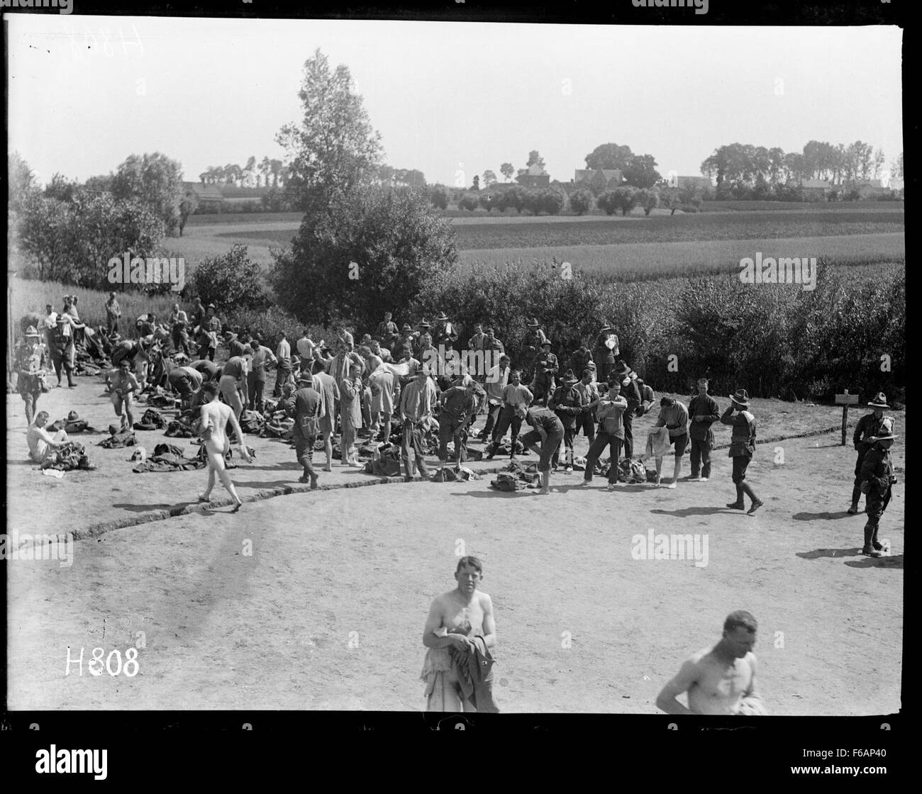 This historical photograph captures New Zealand troops dressing after a ...
