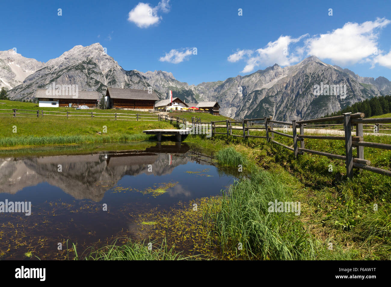 Rural scene in Alps with a lake in the foreground. Austria, Walderalm. Stock Photo