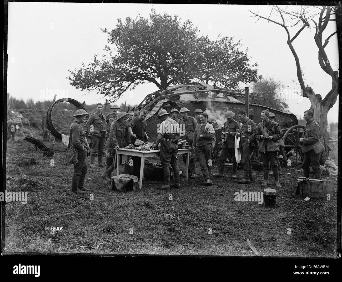 World War I soldiers preparing a meal near a damaged Stock Photo