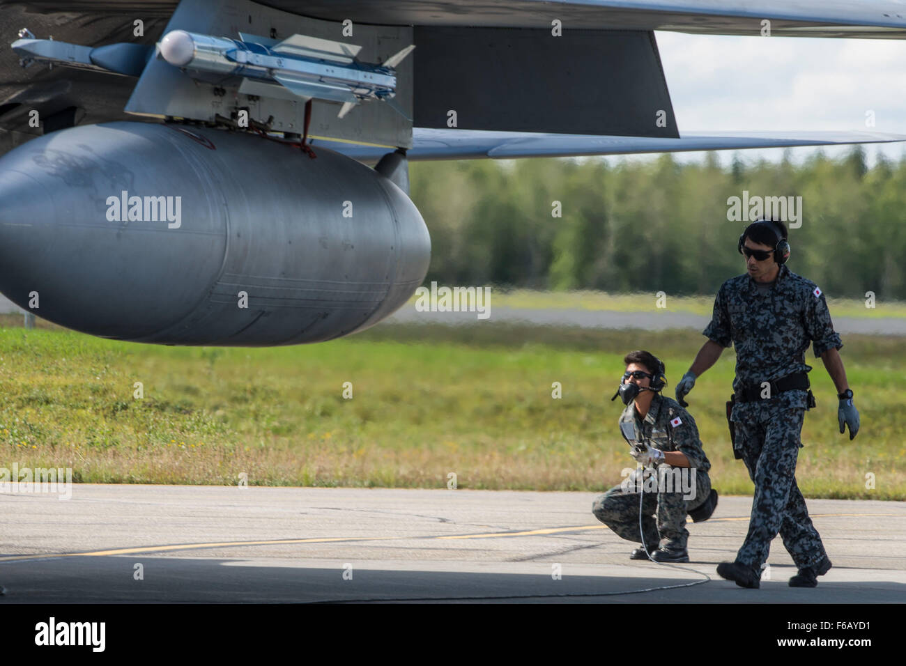 A Japan Air Self-Defense Force (JASDF) crew chief performs pre-flight inspections on an F-15J Eagle at Eielson Air Force Base, Alaska, Aug. 14, 2015, during Red Flag-Alaska (RF-A) 15-3. RF-A is a series of Pacific Air Forces commander-directed field training exercises for U.S. and partner nation forces, providing combined offensive counter-air, interdiction, close air support and large force employment training in a simulated combat environment. (U.S. Air Force photo by Staff Sgt. Joshua Turner/Released) Stock Photo