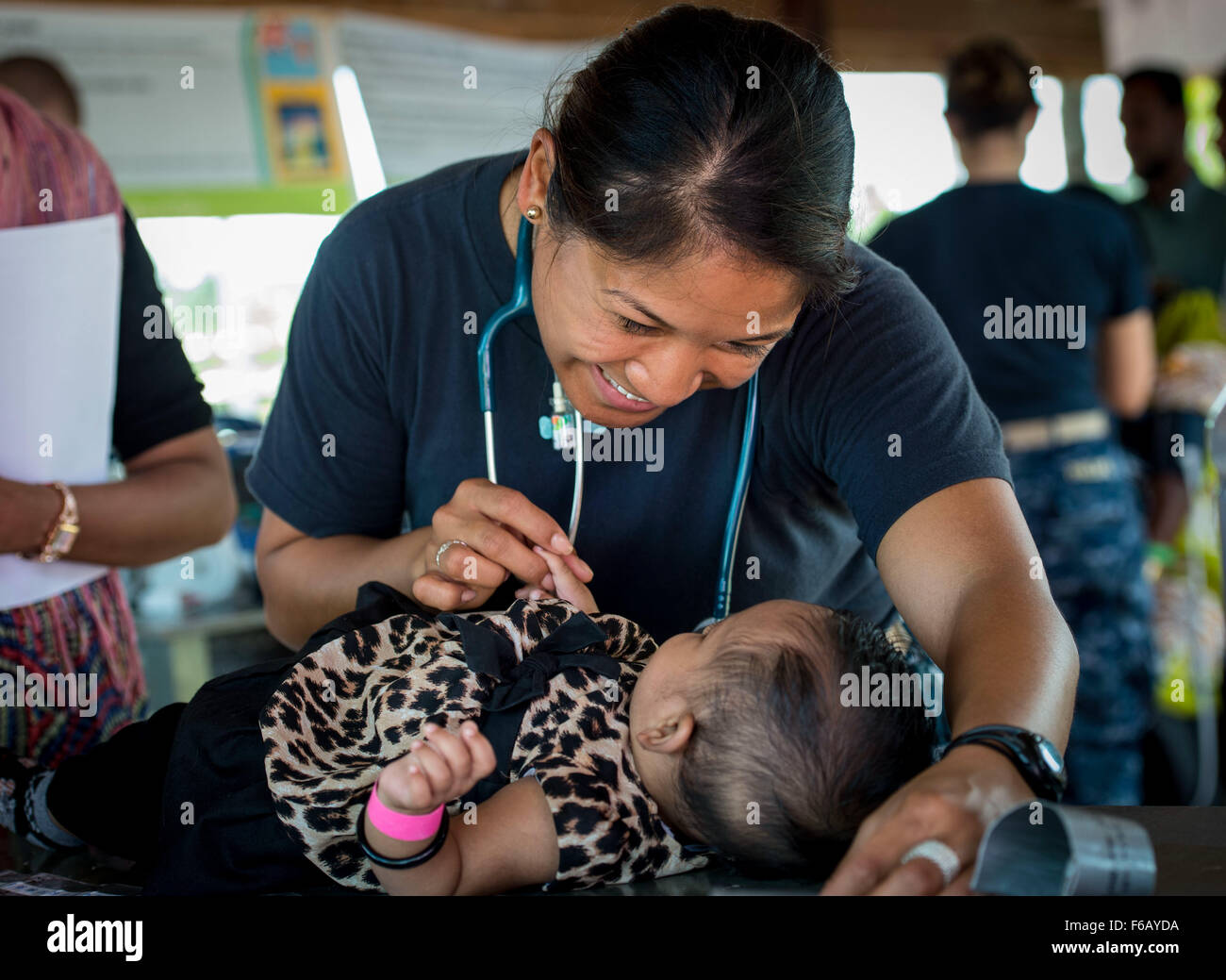 U.S. Navy Lt. Cmdr. Hannah Castillo, a nurse from Urbana, Md., measures a Fijian baby’s height during Pacific Partnership 2015 (PP15) in Savusavu, Fiji, 12 June 2015. Service members and non-governmental organizations from the hospital ship USNS Mercy (T-AH 19) held a community health engagement in Seaqaqa, Fiji, and surrounding areas. The Mercy is currently participating in  PP15 which is in its 10th iteration and is the largest annual multilateral humanitarian assistance and disaster relief preparedness mission conducted in the Indo-Asia-Pacific region. While training for crisis conditions,  Stock Photo