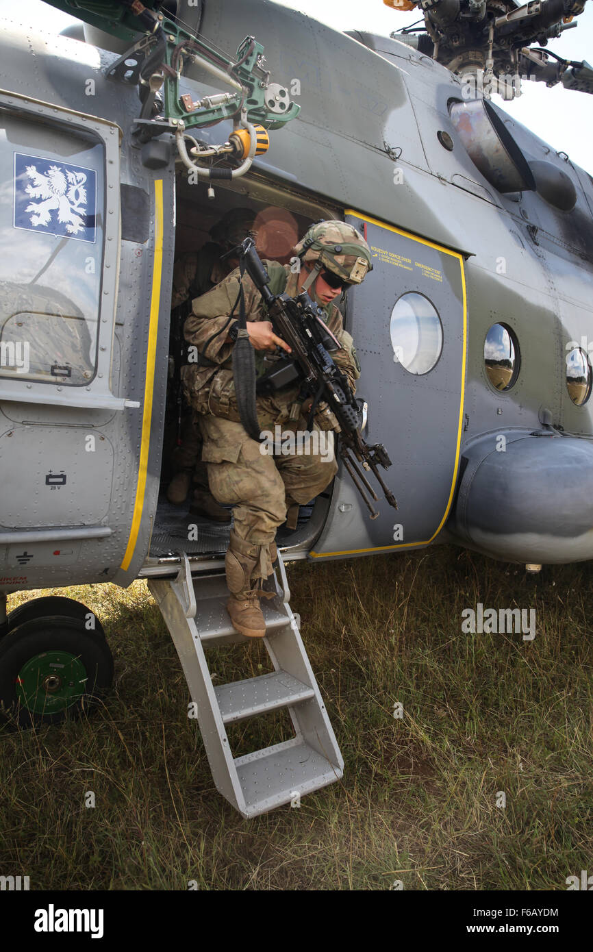 A U.S. Soldier assigned to the 1st Battalion, 503rd Infantry Regiment, 173rd Airborne Brigade Combat Team exits a Russian Air Force Mil Mi-17 helicopter while conducting hot and cold load training during exercise Allied Spirit II at the U.S. Army’s Joint Multinational Readiness Center in Hohenfels, Germany, Aug. 18, 2015. Allied Spirit is a multinational ground force training exercise designed to increase interoperability between U.S. and NATO forces. (U.S. Army photo by Spc. Shardesia Washington/Released) Stock Photo