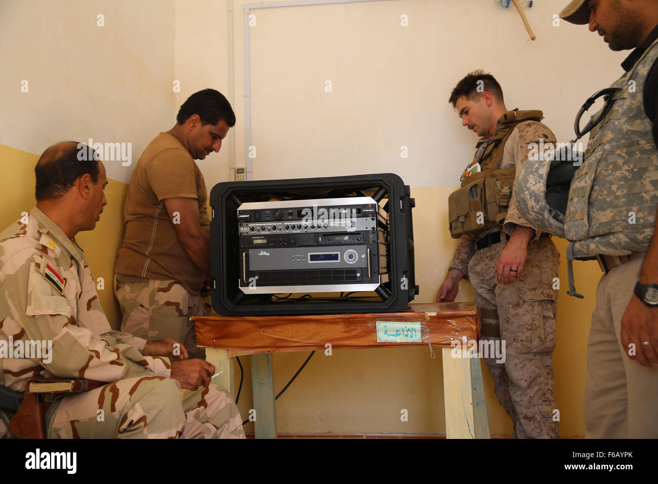 U.S. Marine Staff Sgt. Eric Alabiso, right, a military information operations advisor with Task Force Al Asad, helps an Iraqi soldier with the 7th Iraqi Army Division set up a Radio in a Box (RIAB) at Al Asad Air Base, Iraq, Sept. 28, 2015. The RIAB was provided by Iraq’s Ministry of Defense through the Iraq Train and Equip Fund. The fund was established by Combined Joint Task Force – Operation Inherent Resolve (CJTF-OIR), a part of the multinational coalition force that helps improve the Iraqi military’s ability to fight against the Islamic State of Iraq and the Levant (ISIL) by providing tra Stock Photo
