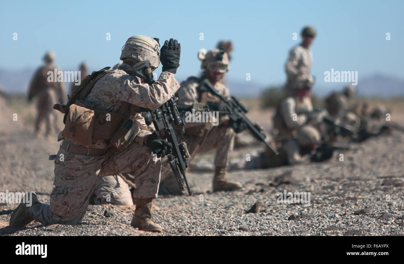 U.S. Marines with 2nd Battalion, 7th Marine Regiment, 1st Marine Division, 1st Marine Expeditionary Force set up perimeter security during a fast rope exercise at Auxiliary Airfield 2, Yuma, Ariz., Oct. 2, 2015. This training evolution is apart of Weapons and Tactics Instructor (WTI) 1-16, a seven week training event, hosted by Marine Aviation Weapons and Tactics Squadron One (MAWTS-1) cadre, which emphasizes operational integration of the six functions of Marine Corps aviation in support of a Marine Air Ground Task Force. MAWTS-1 provides standardized advanced tactical training and certificat Stock Photo