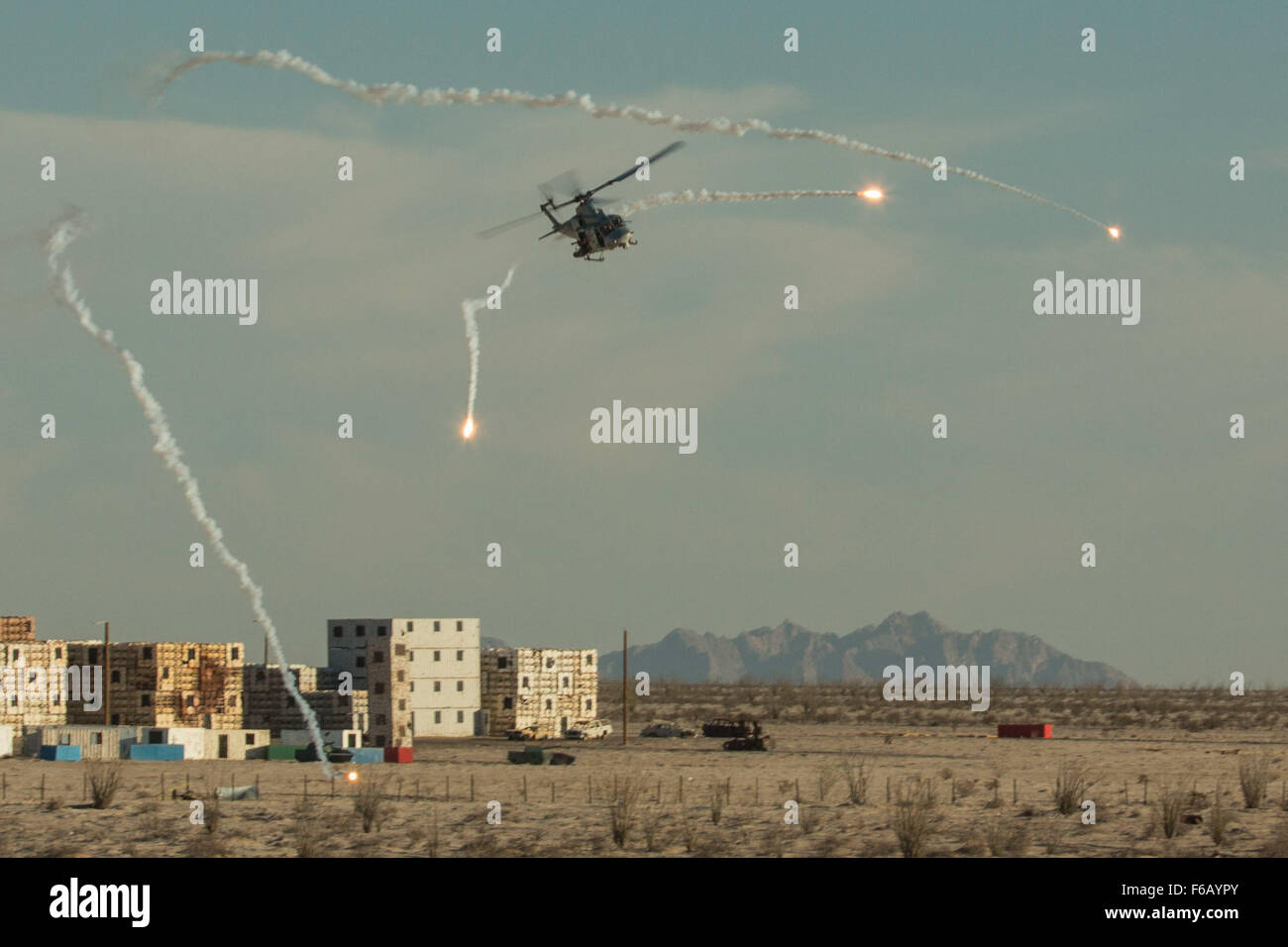 A U.S. Marine Corps UH-1Y Venom provides urban close air support at Yodaville, Yuma, Ariz., on Oct. 2, 2015. This exercise was part of the Weapons and Tactics Instructor (WTI) Course 1-16, a seven week training event, hosted by Marine Aviation Weapons and Tactics Squadron One (MAWTS-1) cadre, which emphasizes operational integration of the six functions of Marine Corps aviation in support of a Marine Corps Air Ground Task Force. MAWTS-1 provides standardized advanced tactical training and certification of unit instructor qualifications to support Marine Aviation Training and Readiness and assi Stock Photo