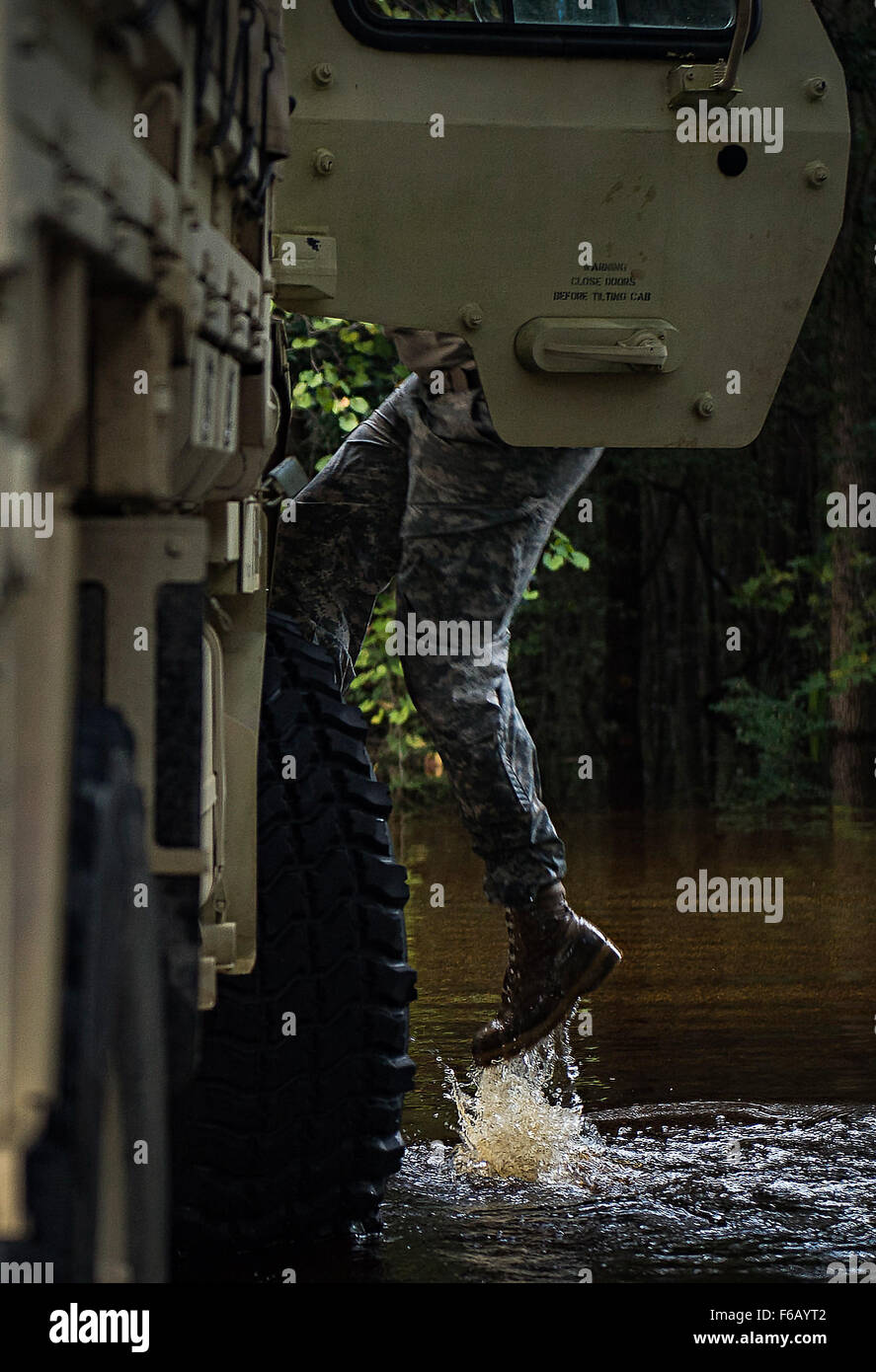Flood water from the Edisto River quickly rose during high tide, while South Carolina National Guard Soldiers helped residents protect their property Oct. 9, 2015 in Parkers Ferry, S.C. The historic flooding, which has caused damage, destruction and death throughout South Carolina, has been the result of record-setting rainfall during what is being considered a 1,000-year event delivered by Hurricane Joaquin as it traveled up the East Coast. (U.S. Air Force photo by Staff Sgt. Perry Aston/Released) Stock Photo