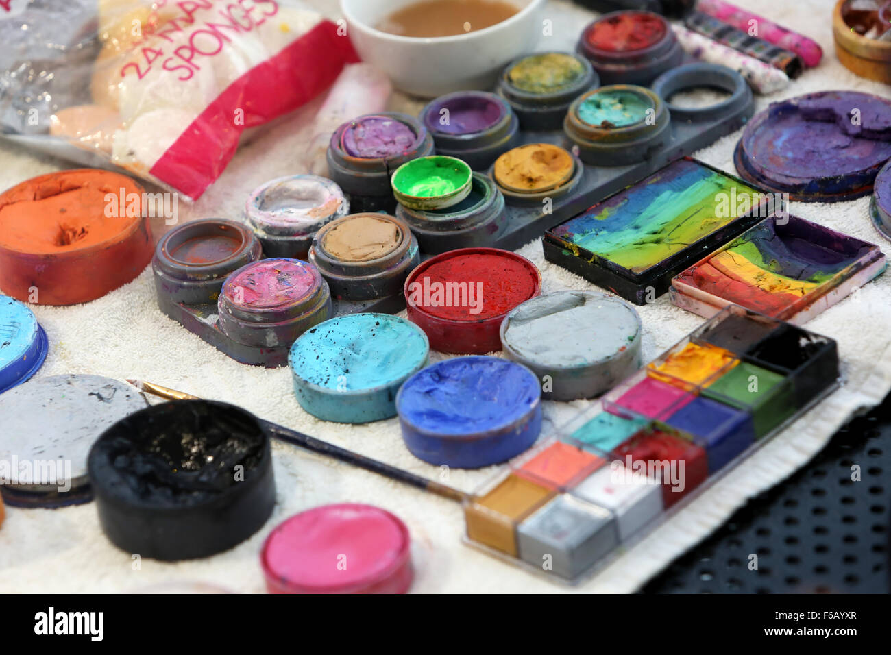 A selection of paints on a table ready to be used for face painting at a children's party in Brighton, East Sussex, UK. Stock Photo