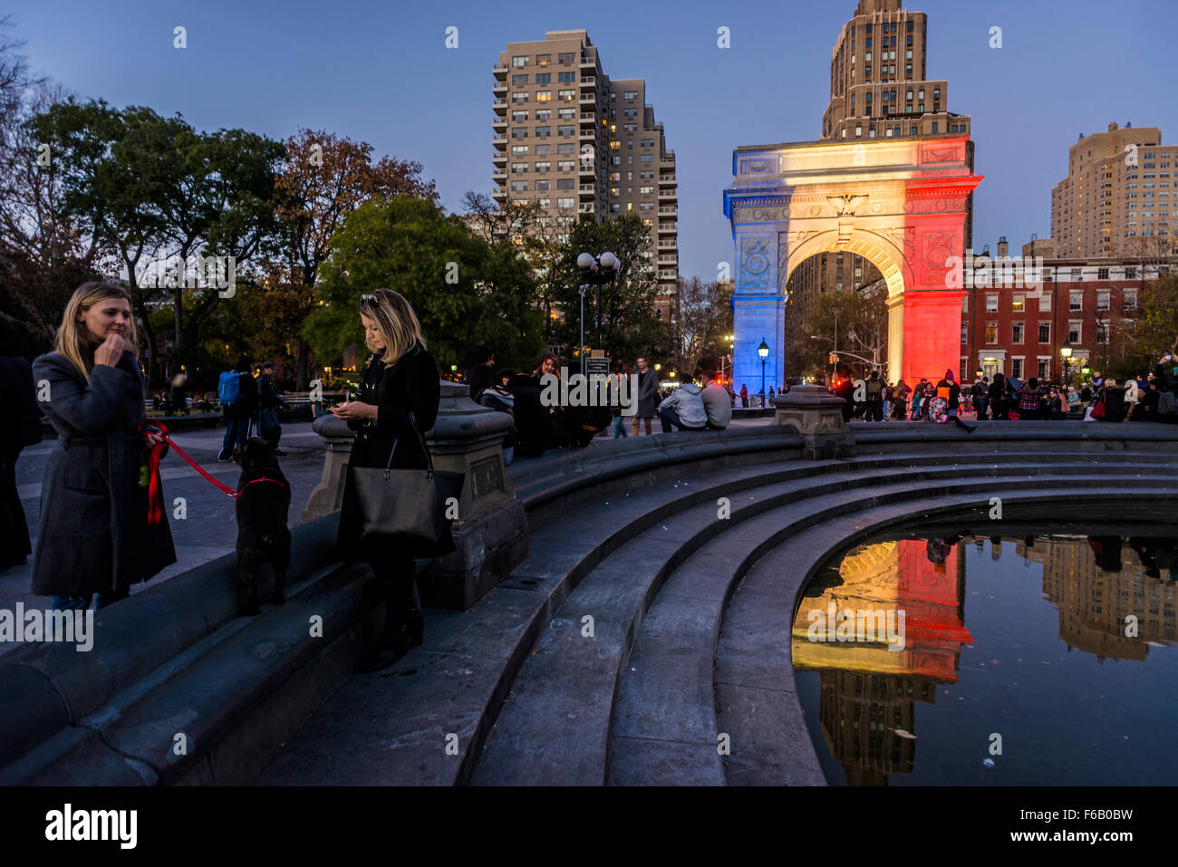 New York, NY - 15 November 2015 NYC  The arch in Washington Square Park alights up in solidarity with Paris.  Beneath the arch is a candlelight shrine to commemorate the victims of the 13 November Paris terror attacks. Credit: Stacy Walsh Rosenstock/Alamy Live News Stock Photo