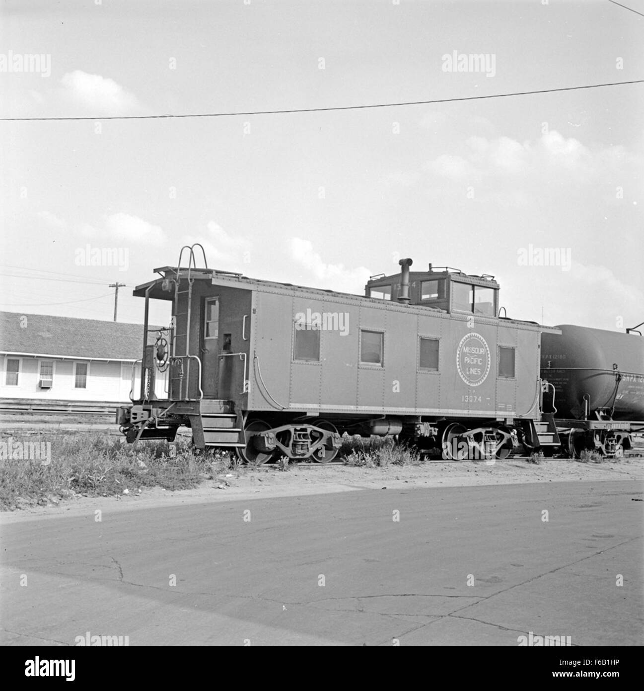 Texas & Pacific Caboose No. 13074 represents a key component of historical railroad transport, showcasing the detailed design and function of a caboose in freight operations. Stock Photo
