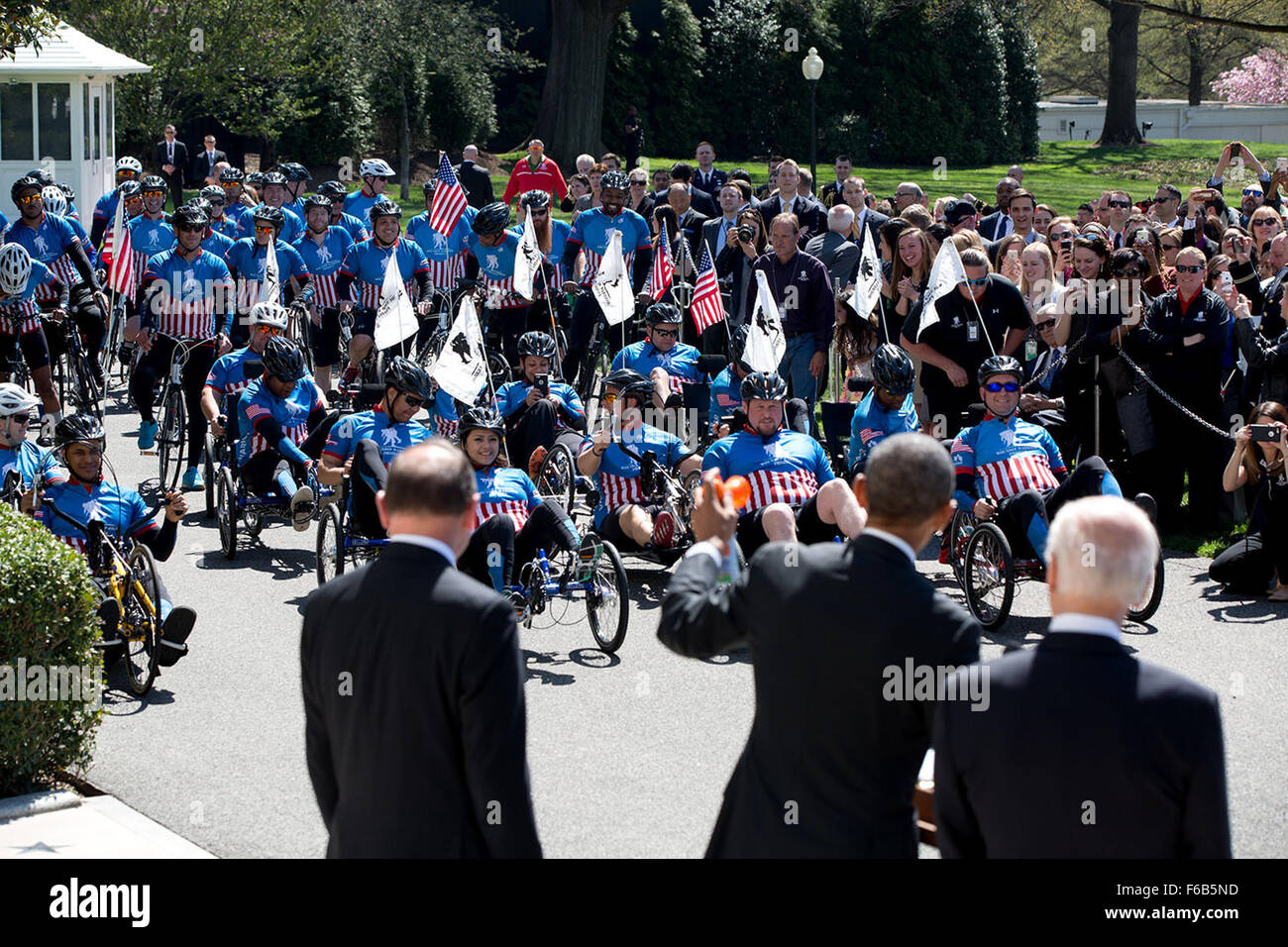 President Barack Obama, with Vice President Joe Biden and Veterans Affairs Secretary Robert McDonald, uses an air horn to start the eighth annual Wounded Warrior Project's Soldier Ride on the South Lawn of the White House, April 16, 2015. Stock Photo