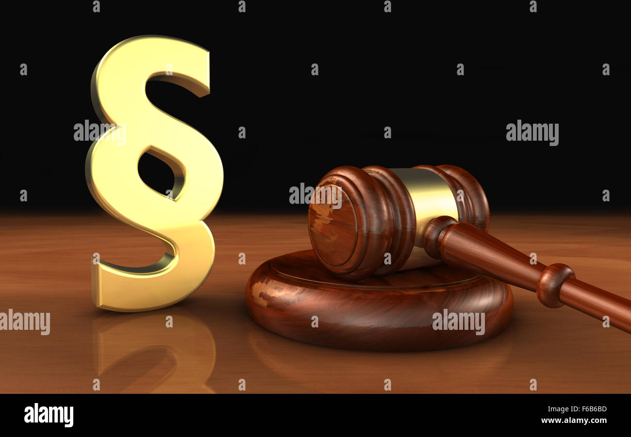 Law, legality and legal system concept with a golden paragraph symbol and a wooden gavel on a desktop with black background. Stock Photo