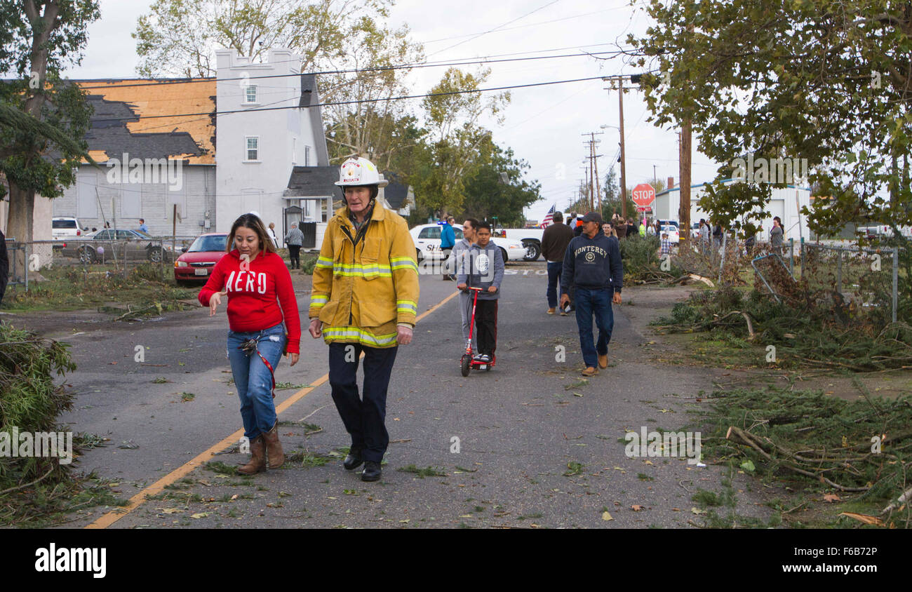Denair, CA, USA. 15th Nov, 2015. A tornado ripped through Denair, California Sunday Nov. 15th 2015 afternoon causing heavy damage to several building including a church. A chaplin from Denair Fire Department walks down Zeering Rd in Denair Ca with a lady after a tornado caused major damage to several building in the area. Credit:  Marty Bicek/ZUMA Wire/Alamy Live News Stock Photo