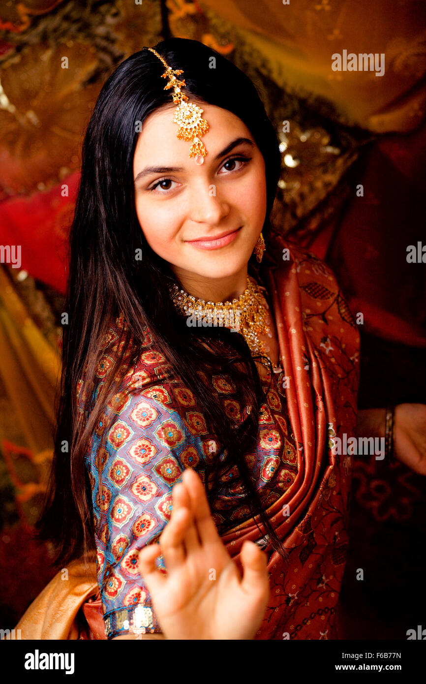 beauty sweet real indian girl in sari smiling on black background close