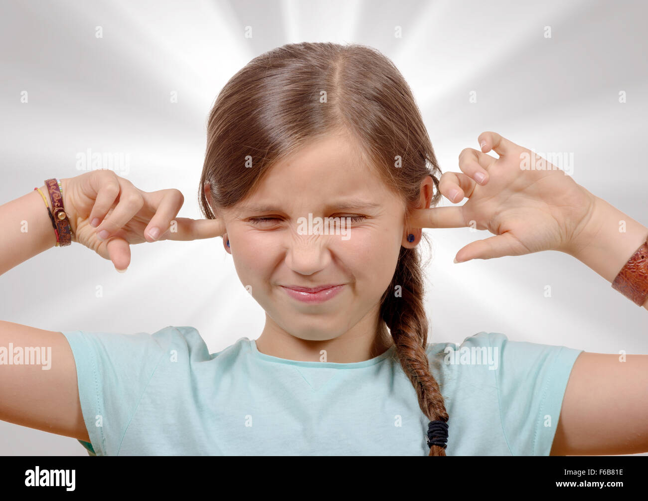 a little girl covering her ears,to say stop making loud noise giving me