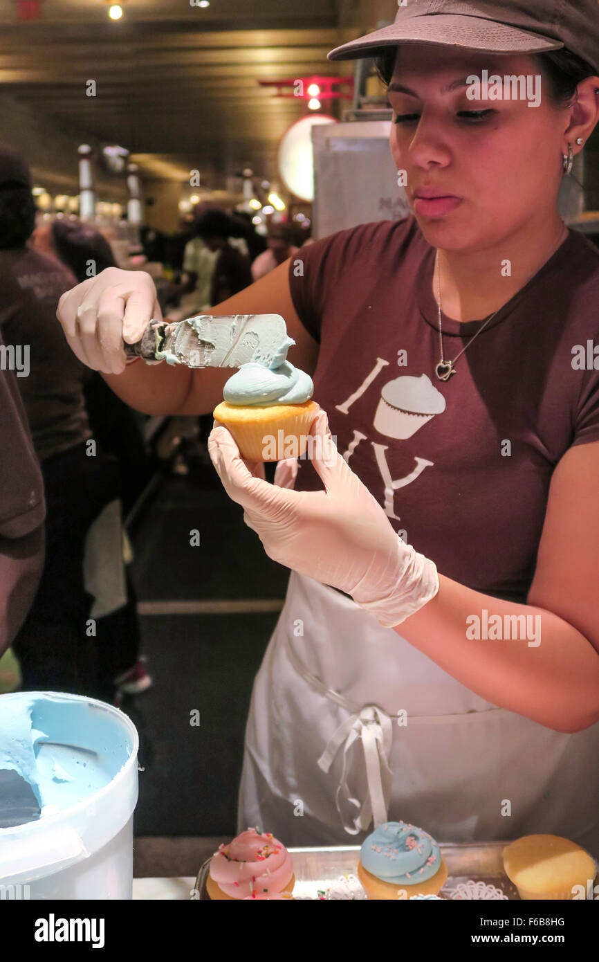 Worker Frosting Cupcakes, Magnolia Bakery, Grand Central Terminal, NYC, USA Stock Photo