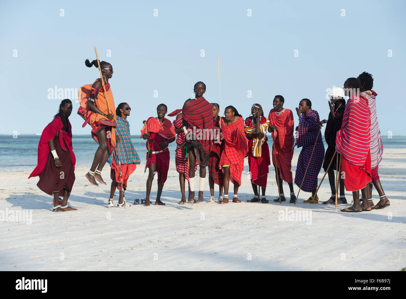 Tanzania Zanzibar Maasai men performing jumping dance on the beach Stock Photo