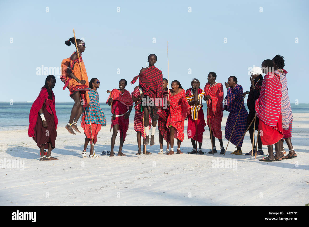 Tanzania Zanzibar Maasai men performing jumping dance on the beach Stock Photo