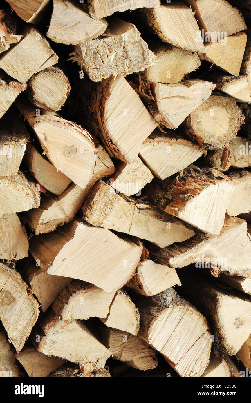 Dry chopped firewood logs in a pile. Nature abstract background with stack of firewood. Stock Photo