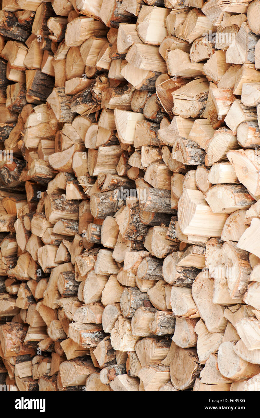 Dry chopped firewood logs in a pile. Nature abstract background with stack of firewood. Stock Photo