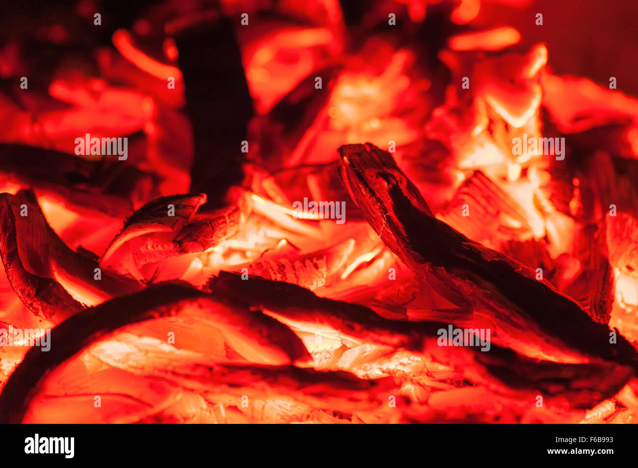 Open fire in fireplace. Closeup of burning stack of firewood with