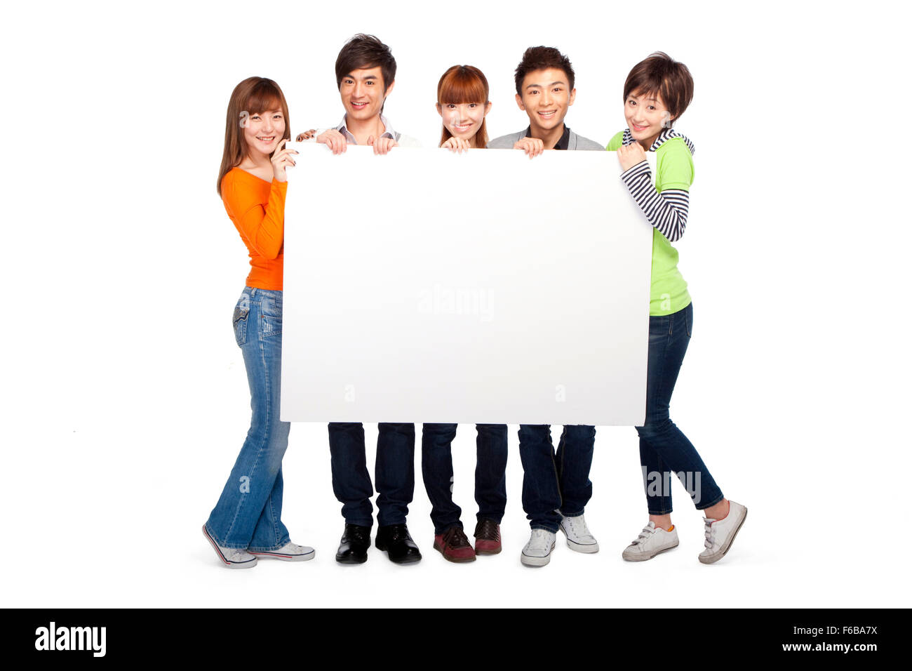 A group of young people holding a blank sign Stock Photo - Alamy
