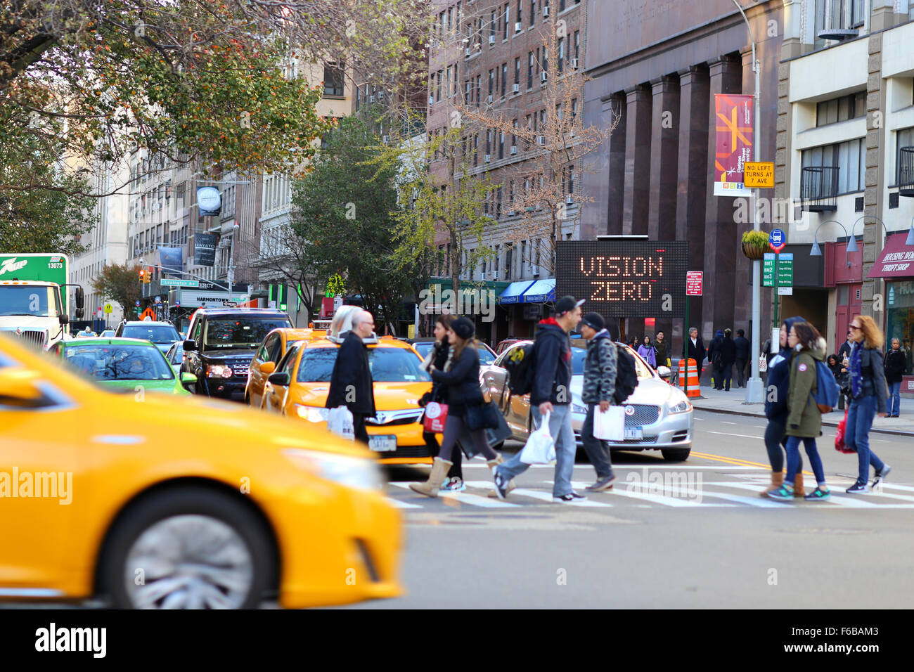 An electronic sign flashes Vision Zero near a New York City intersection Stock Photo